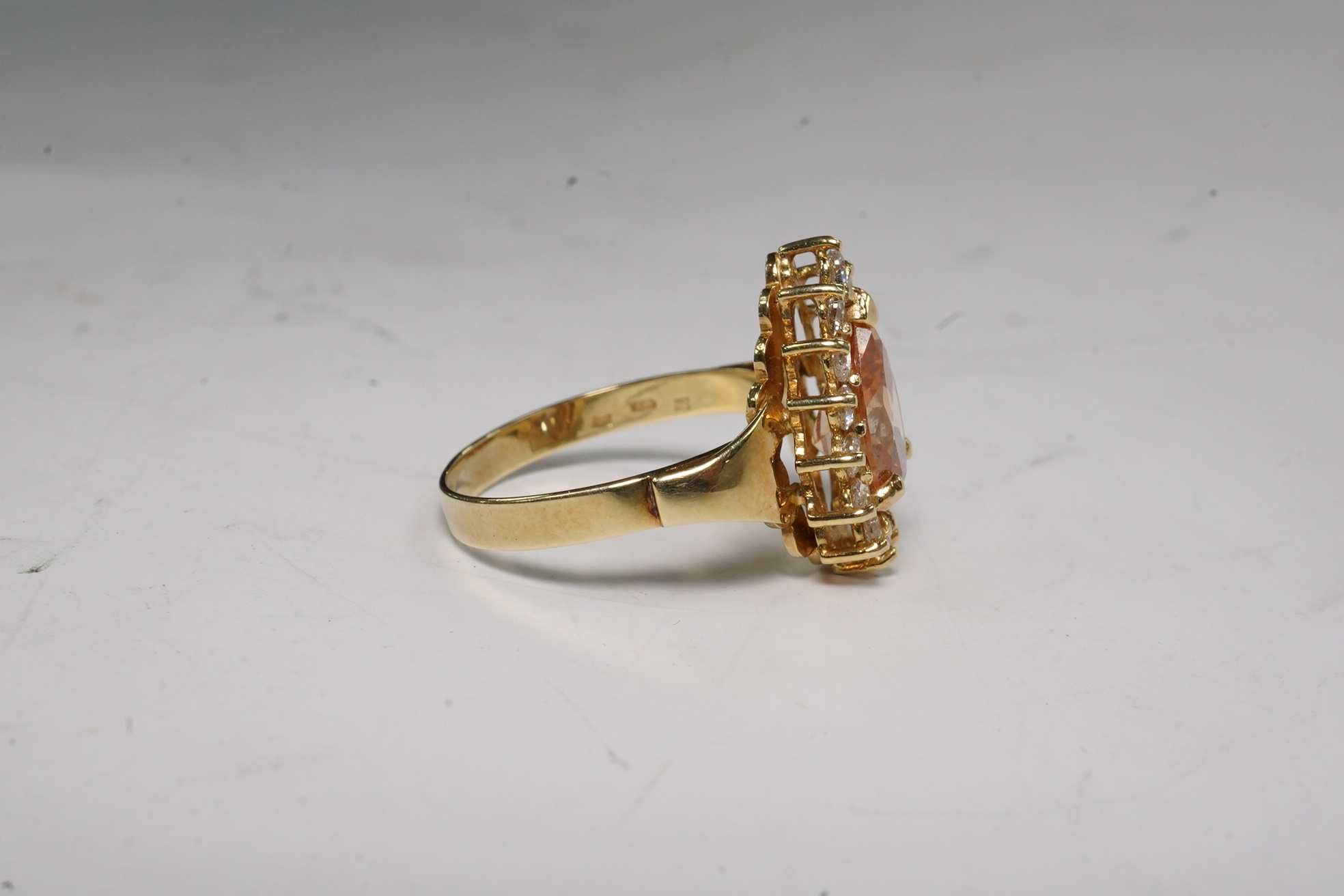 A 14k and simulated diamond set pear shaped cluster ring, size N, gross weight 3.8 grams. Condition - fair to good